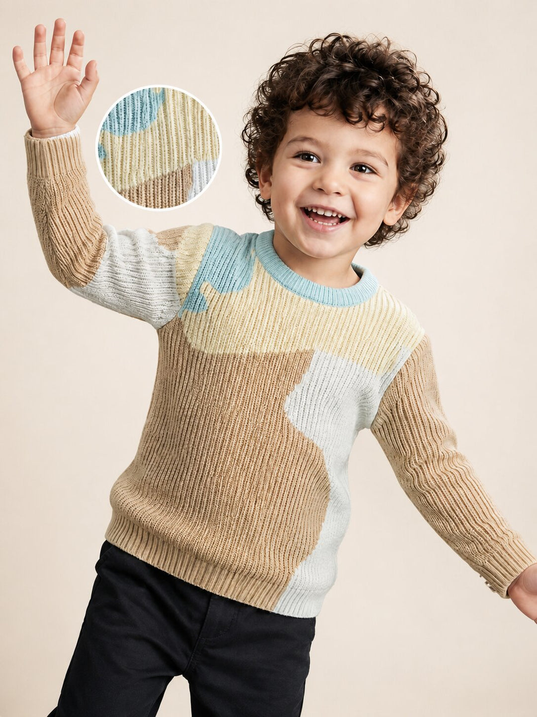 A smiling young boy with curly brown hair waves while wearing a ribbed knit sweater with beige, light blue, and off-white color blocking. A circular inset in the upper left shows a close-up of the knit pattern.