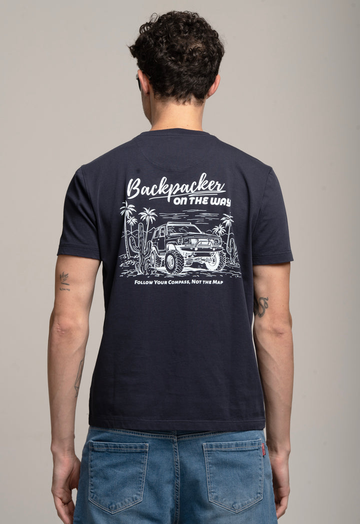 Person wearing a navy t-shirt with a graphic design on the back, standing against a plain background.
