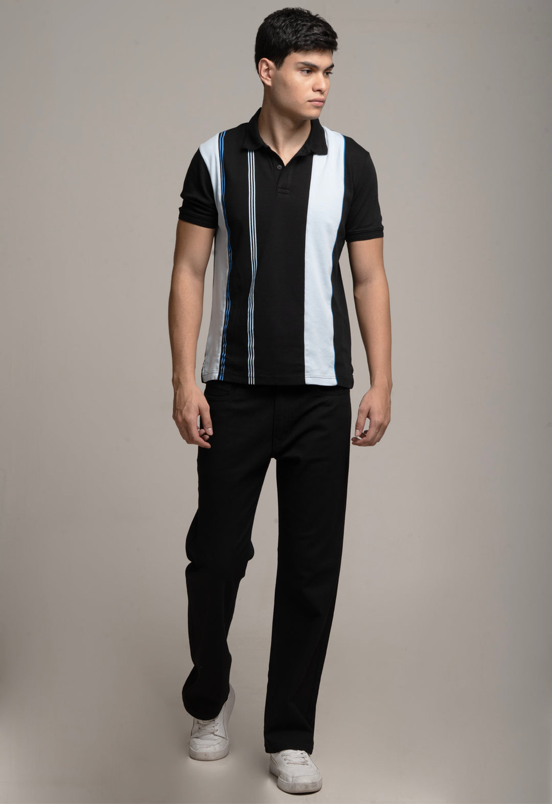 Man wearing a black and white striped shirt with a plain background