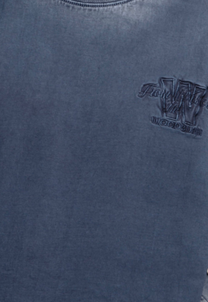 Close-up of a blue garment with a logo on the chest.