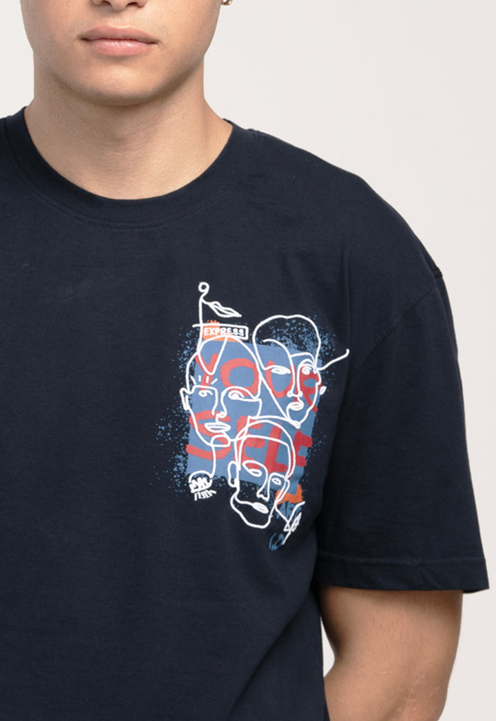 Person wearing a black t-shirt with a graphic design of three stylized faces.