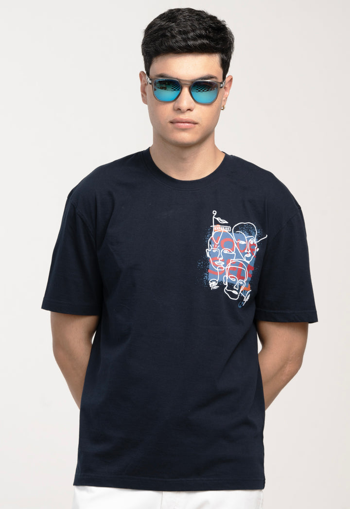 Man wearing a black t-shirt with a graphic design on a plain background