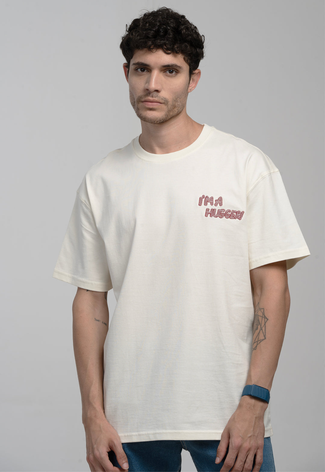 Man wearing a white t-shirt with text on a gray background