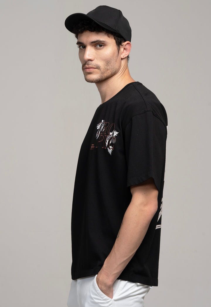 Man wearing a black t-shirt with graphic design on a gray background