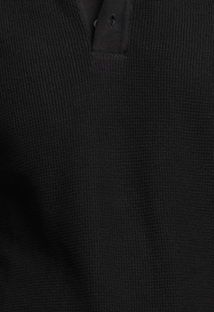 Close-up of a black textured shirt collar
