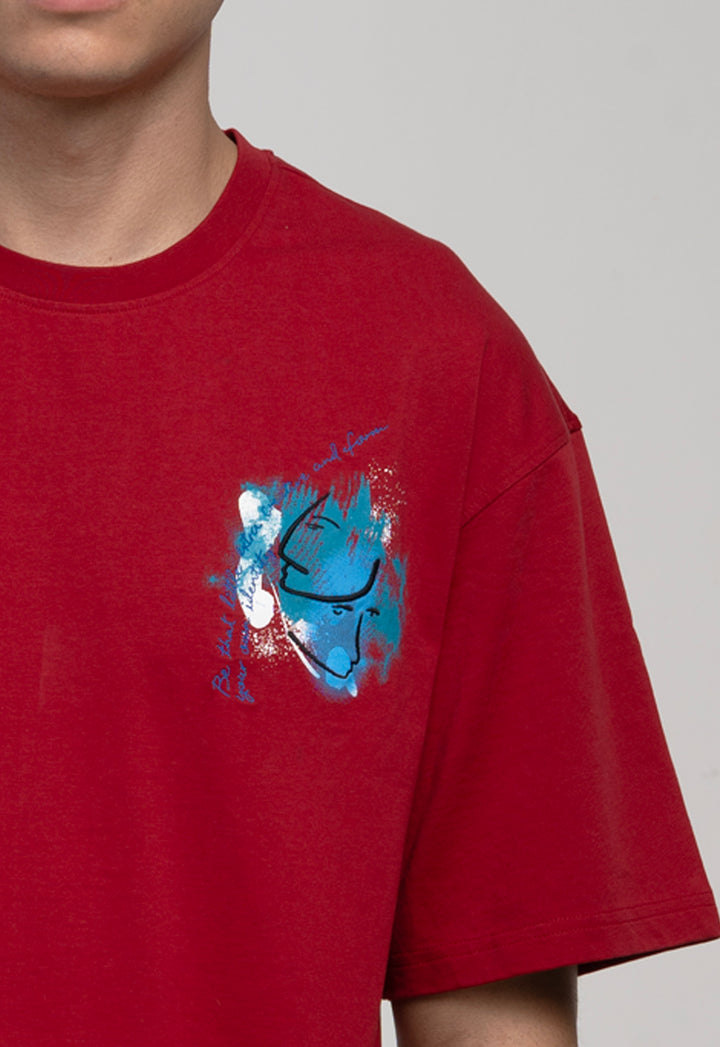 Red t-shirt with a blue graphic design on a plain background