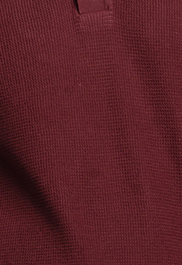 Close-up of a textured brown fabric with a subtle pattern
